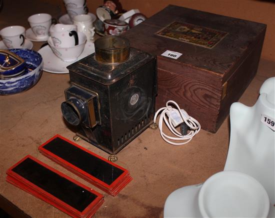 Ernst Plank Gloria tinplate Magic Lantern, c 1900 (later wired) with lens, chimney and 11 slides in original box with trade label(-)